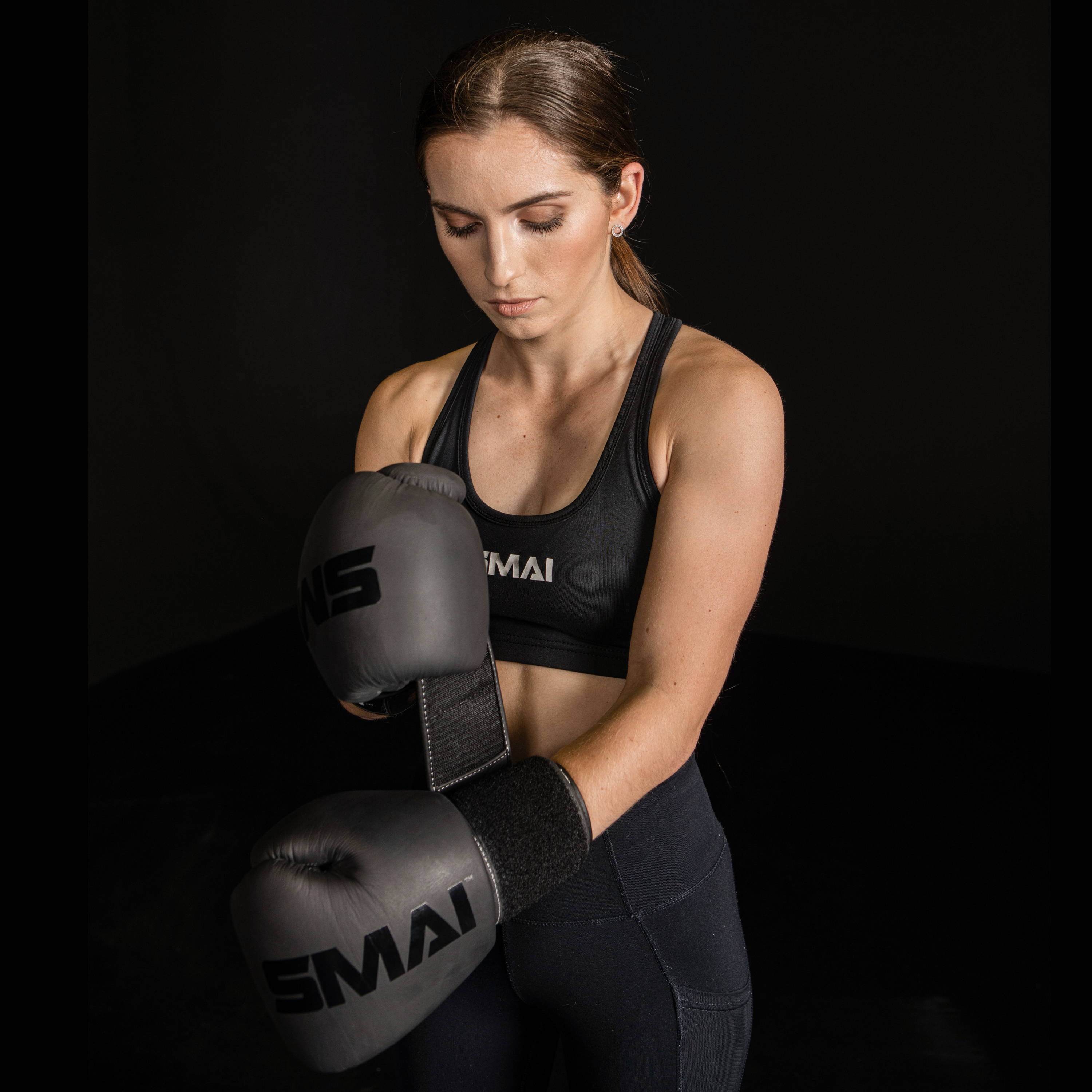 Model putting on a boxing glove