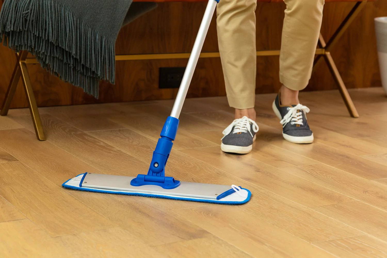 person cleaning floor with microfiber mop