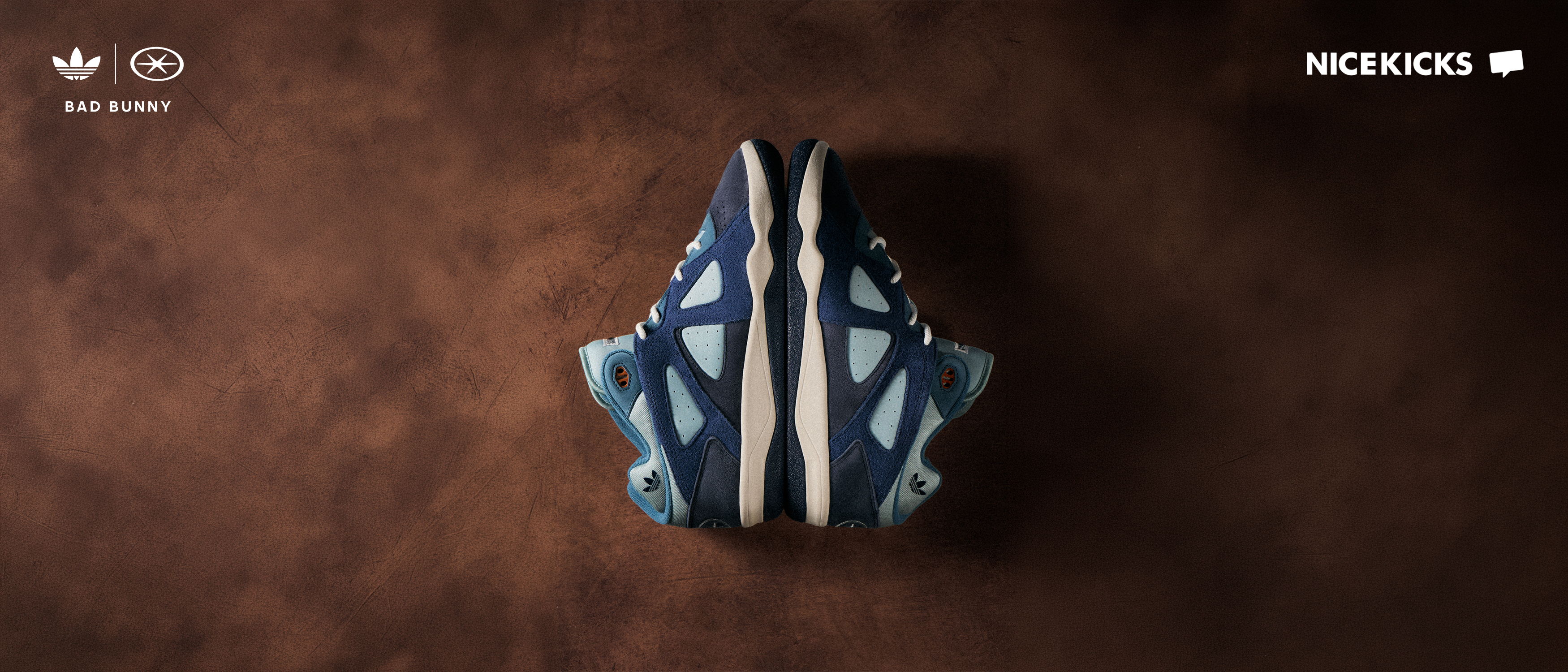 Top view of blue sneakers on a brown surface.