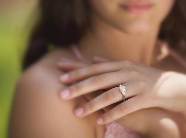 woman's hand with engagement ring