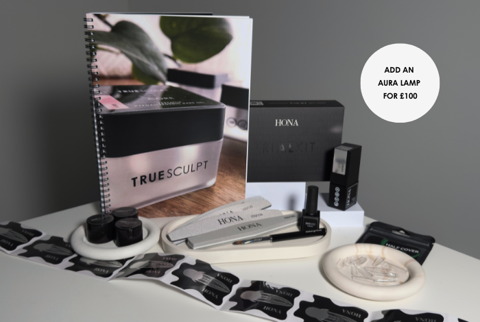 A collection of office supplies and a notebook on a gray background.