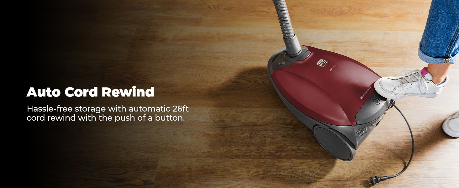 Vacuum cleaner with auto cord rewind feature on wooden floor.