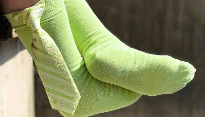 Lime socks with a necktie handing from cuff