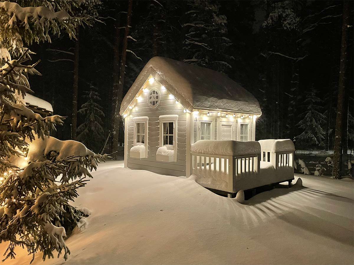 Custom Fully Finished Playhouse with white flower boxes in the snow by WholeWoodPlayhouses