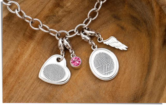 sterling silver charm bracelet with fingerprint heart charm, fingerprint oval charm, pink swarovski birthstone charm, and angel wing charm