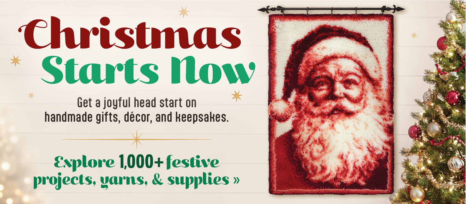 Red and white Santa latch hook next to a Christmas tree with the text: Christmas Starts Now with Santa, featuring festive projects, yarns, and supplies. Christmas starts now. Get a joyful head start on handmade gifts, decor, and keepsakes. Explore 1,000 plus festive projects, yarns, & Supplies.