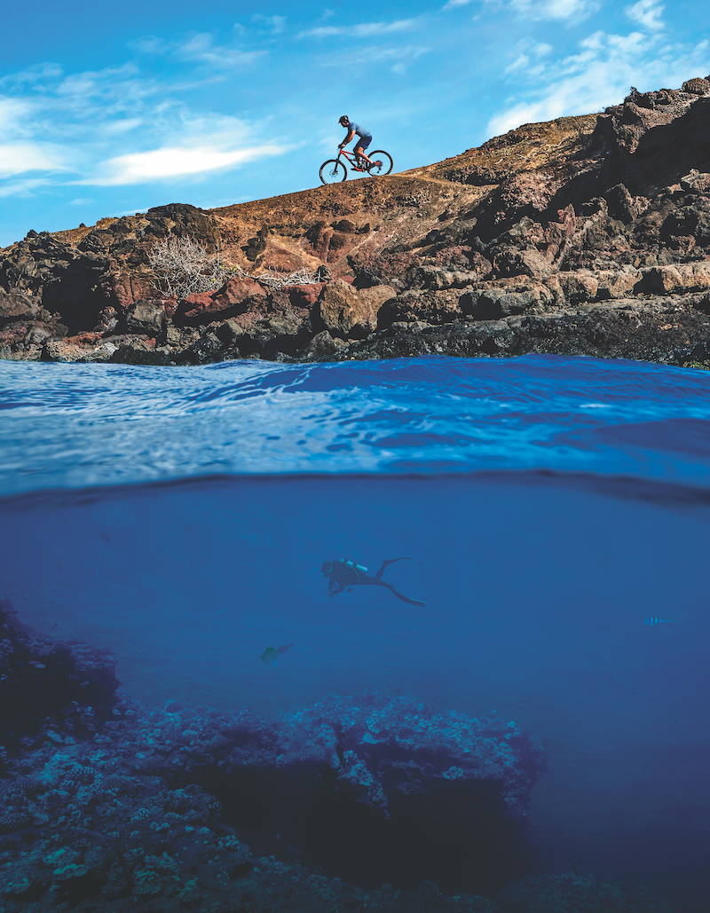Cyclist riding topside while diver swims underwater