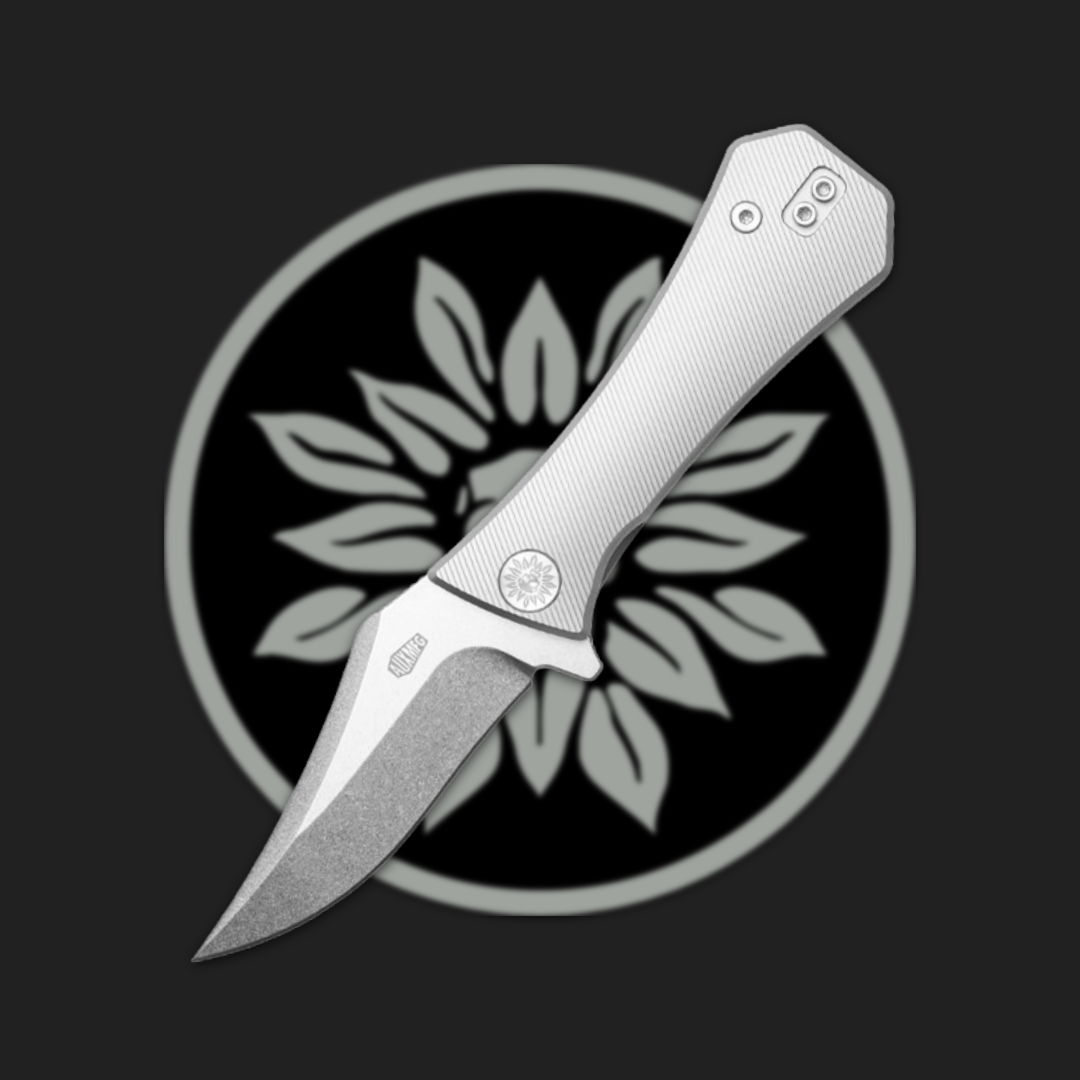 A silver folding knife on a dark background with a floral emblem.