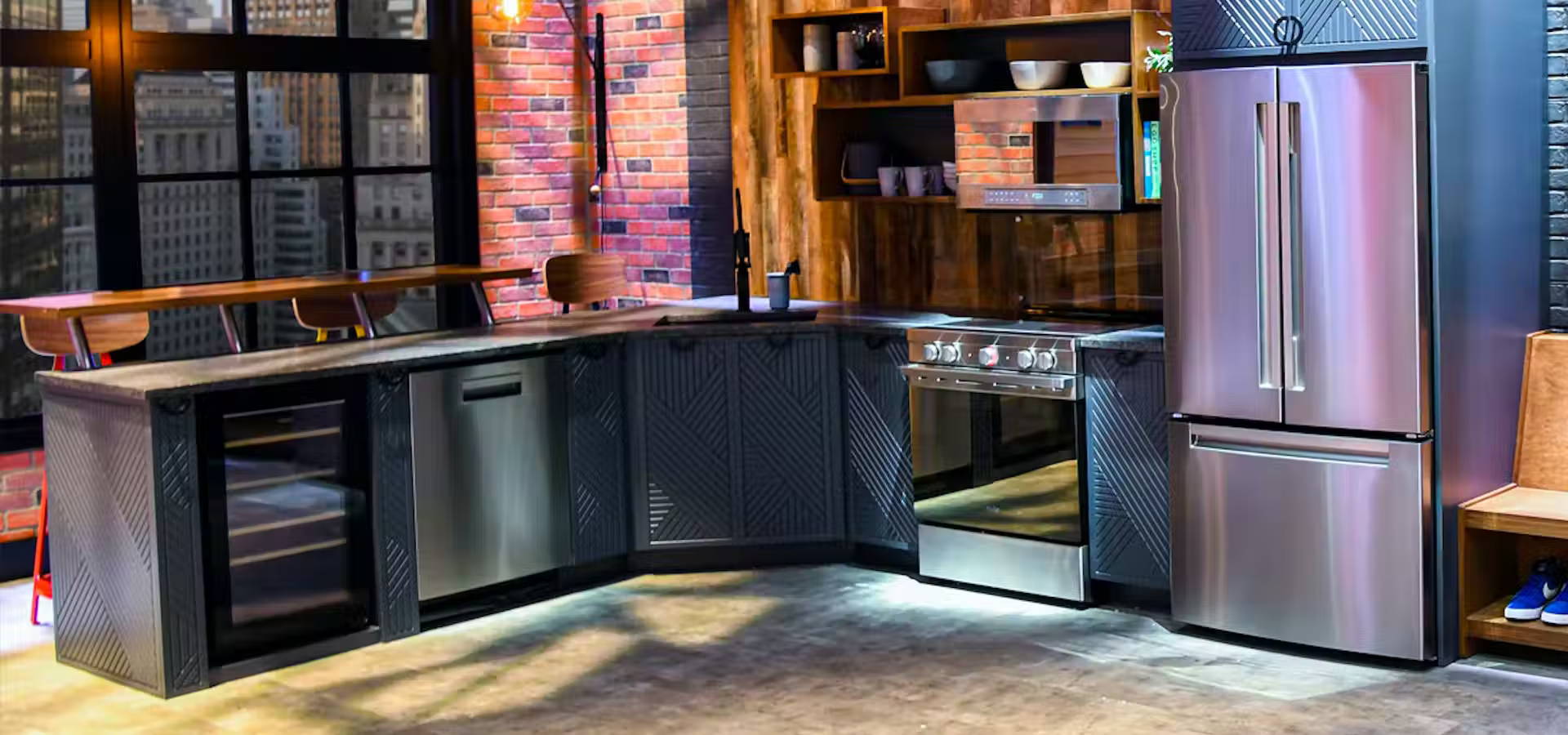 Haier full-size kitchen appliances in a modern loft kitchen with stackable laundry pair.