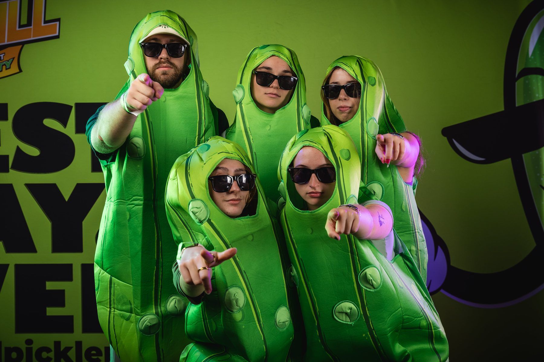 Five guests in pickle costumes posing at the photo booth at The Big Dill.