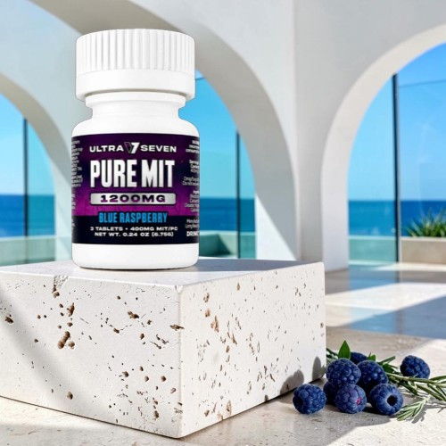 Bottle of dietary supplement on a stone pedestal with ocean view.