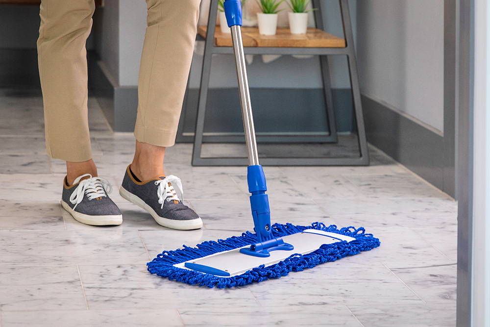person cleaning with microfiber mop