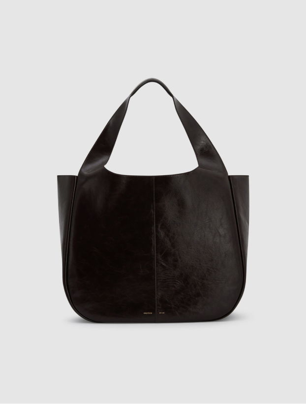 Black leather tote bag with a unique handle design.