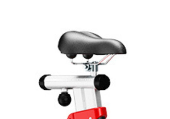 Black bicycle seat on a metal frame with red accents.
