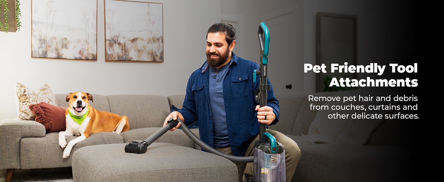 Man vacuuming with pet-friendly attachments and a dog on the couch.