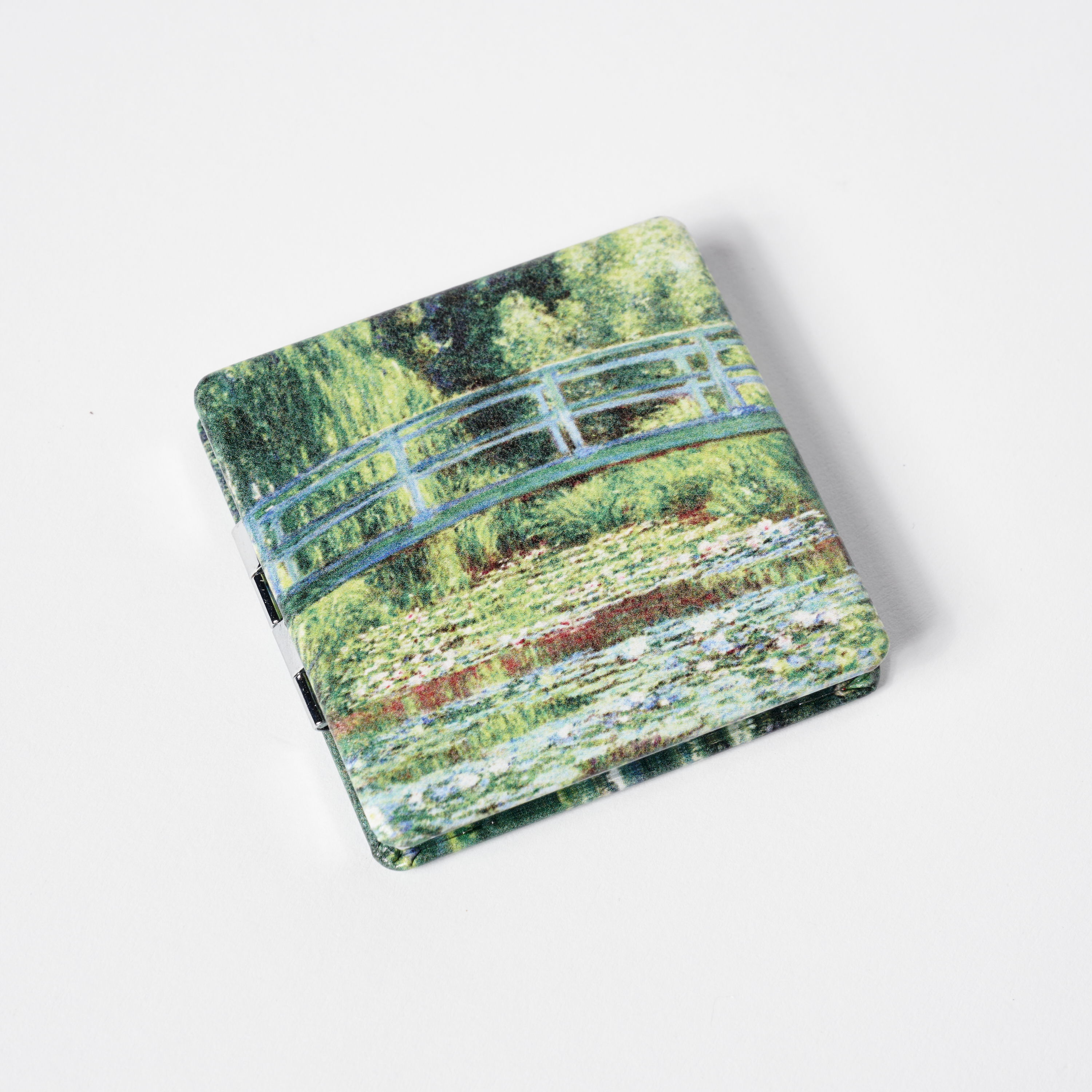 A square notepad featuring Monet's water lilies and bridge artwork.