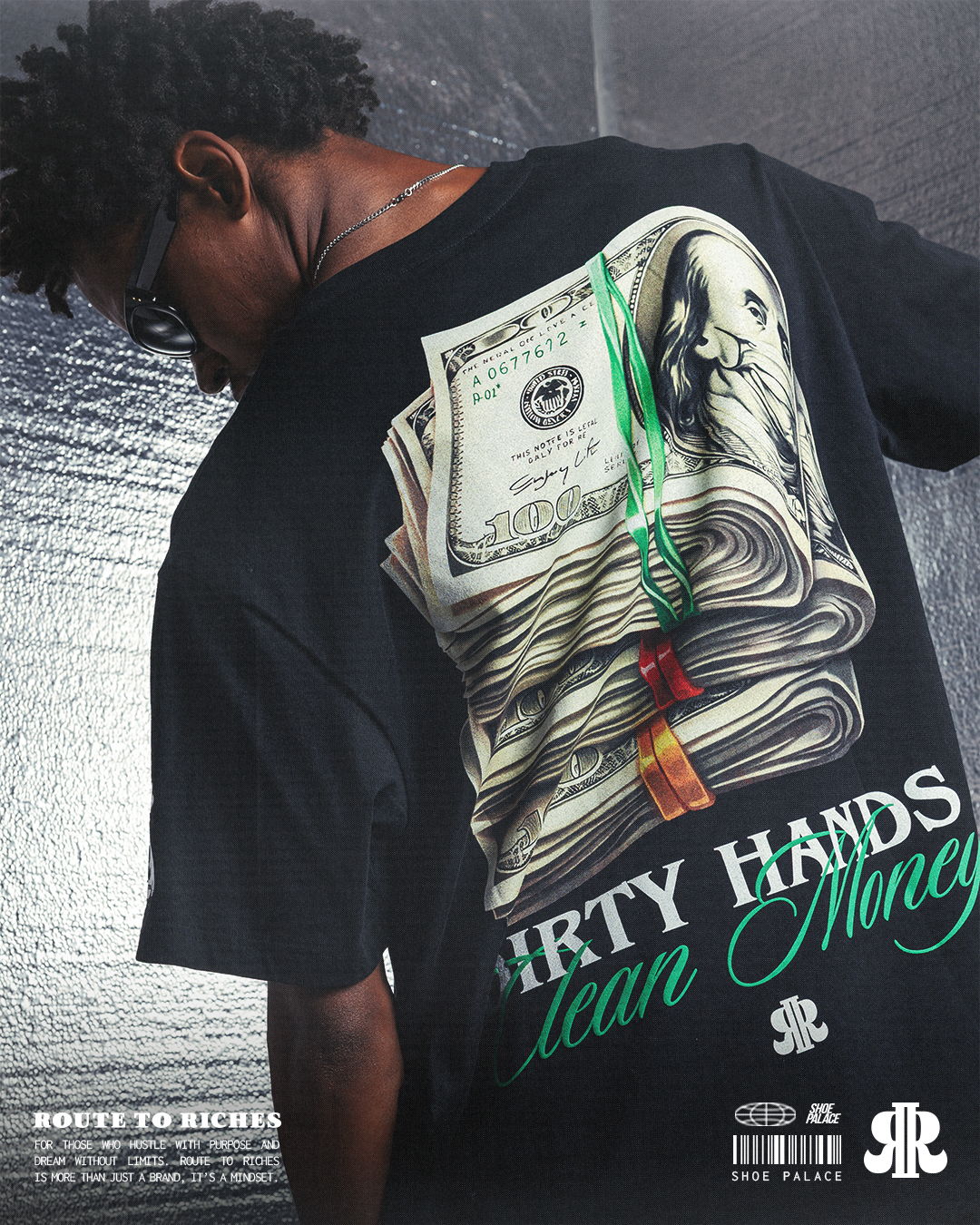 Person wearing a black t-shirt with money graphic on the back.