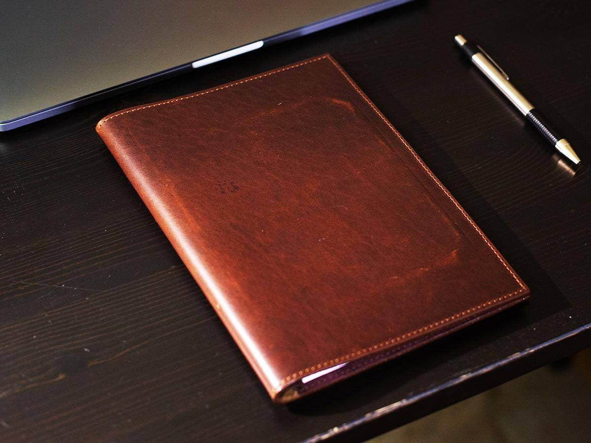 LEATHER PADFOLIO TRADITIONAL - CHESTNUTk of shirts with shoes on top