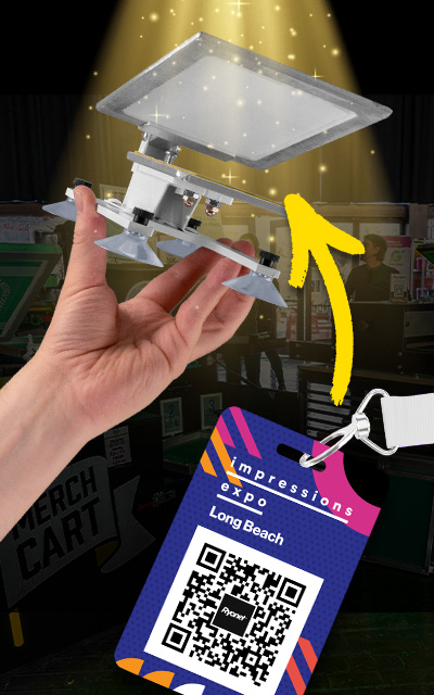 Pigskins and Pigtails Screen Printer Starter Press Mini Edition held in a hand, with an Impressions Expo Long Beach badge and QR code beside it and a yellow arrow pointing to the press above it.
