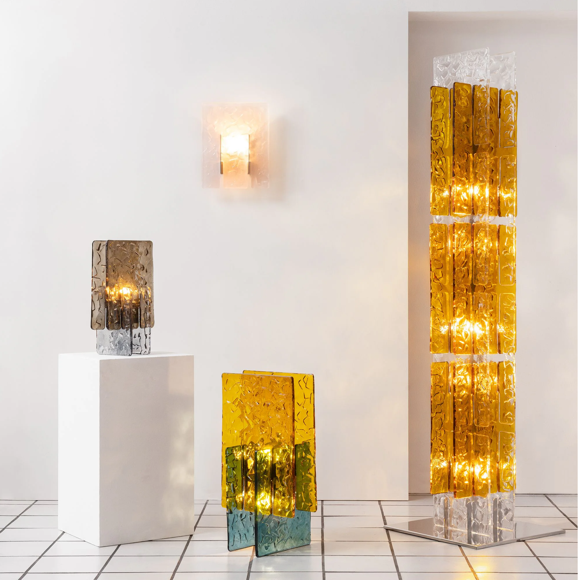 Three decorative lamps in a minimalistic interior setting.