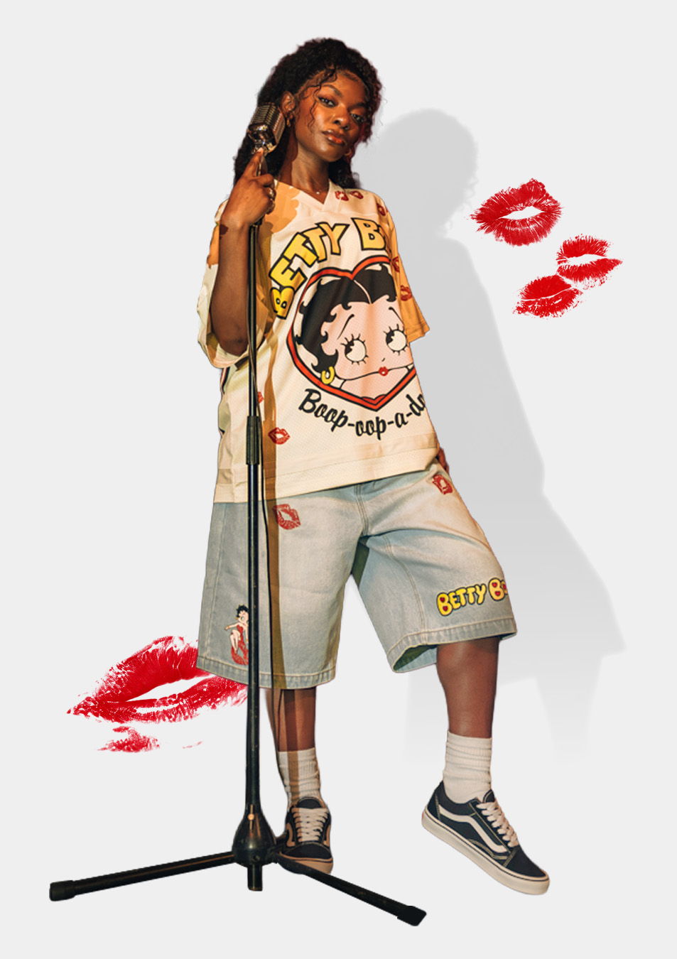 Person in casual outfit standing by a microphone with playful graphics.