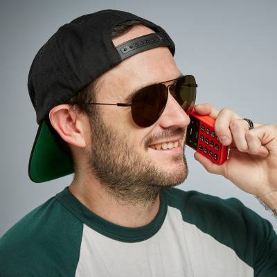 Professional Blind Skateboarder Justin Bishop using the voice-activated commands on the BlindShell Classic 2 Cardinal Red accessible cell phone for the visually impaired .