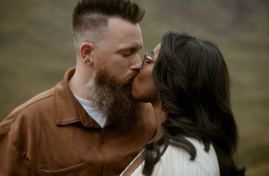 engaged couple kissing in scottish highlands