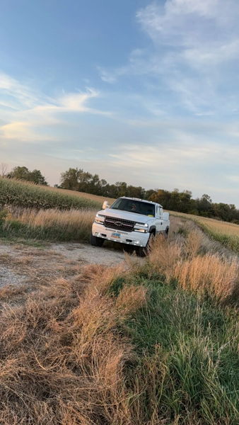Front view of James' white 2001 Chevy Silverado 2500HD parked on a gravel path by a field, install photo 2
