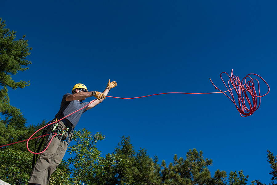 Climber throwing a rope