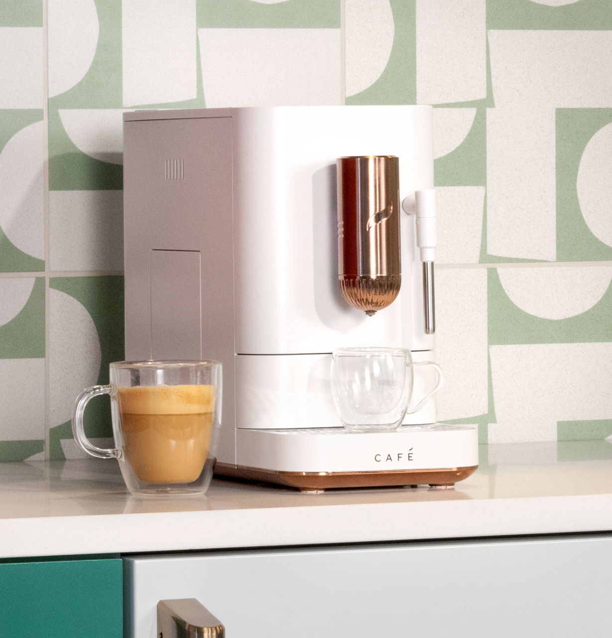 matte white Affetto espresso machine on a countertop with a glass of coffee beside it.
