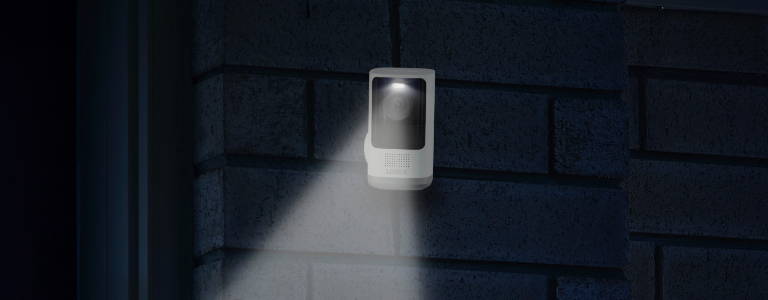 wire-free security camera on wall with deterrence light
