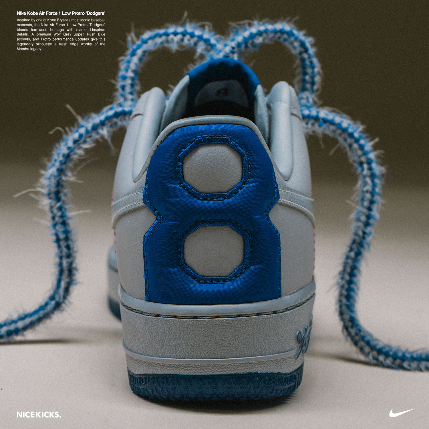 Nike sneaker with blue accents and unique laces, viewed from the back.