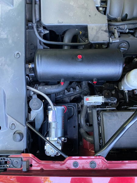 Engine bay black air tank and compressor installed for Conductor's Special 244K on Stephen's 2018 Chevrolet Silverado 1500 photo 4