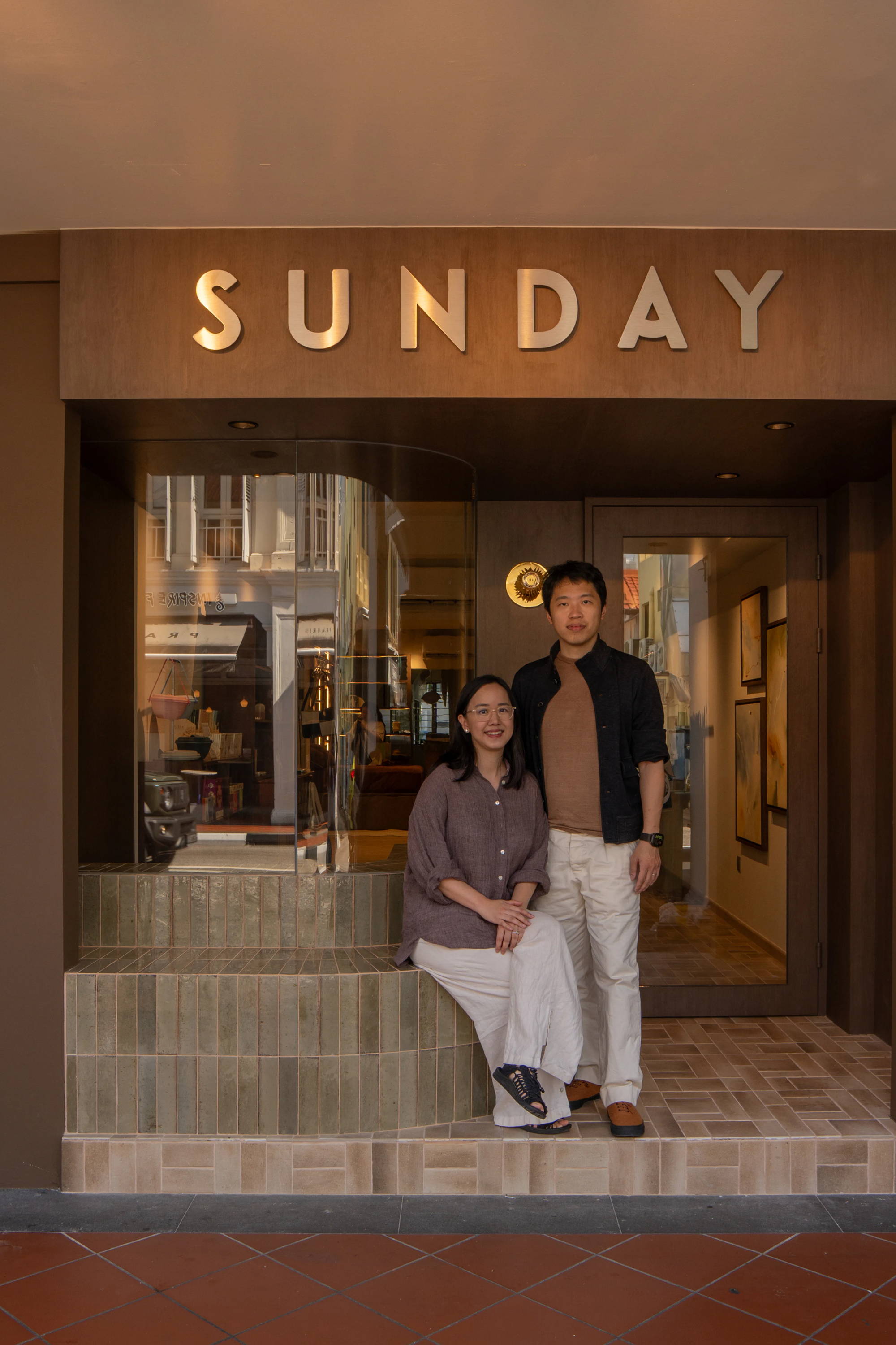 sunday bedding founders in front of the store