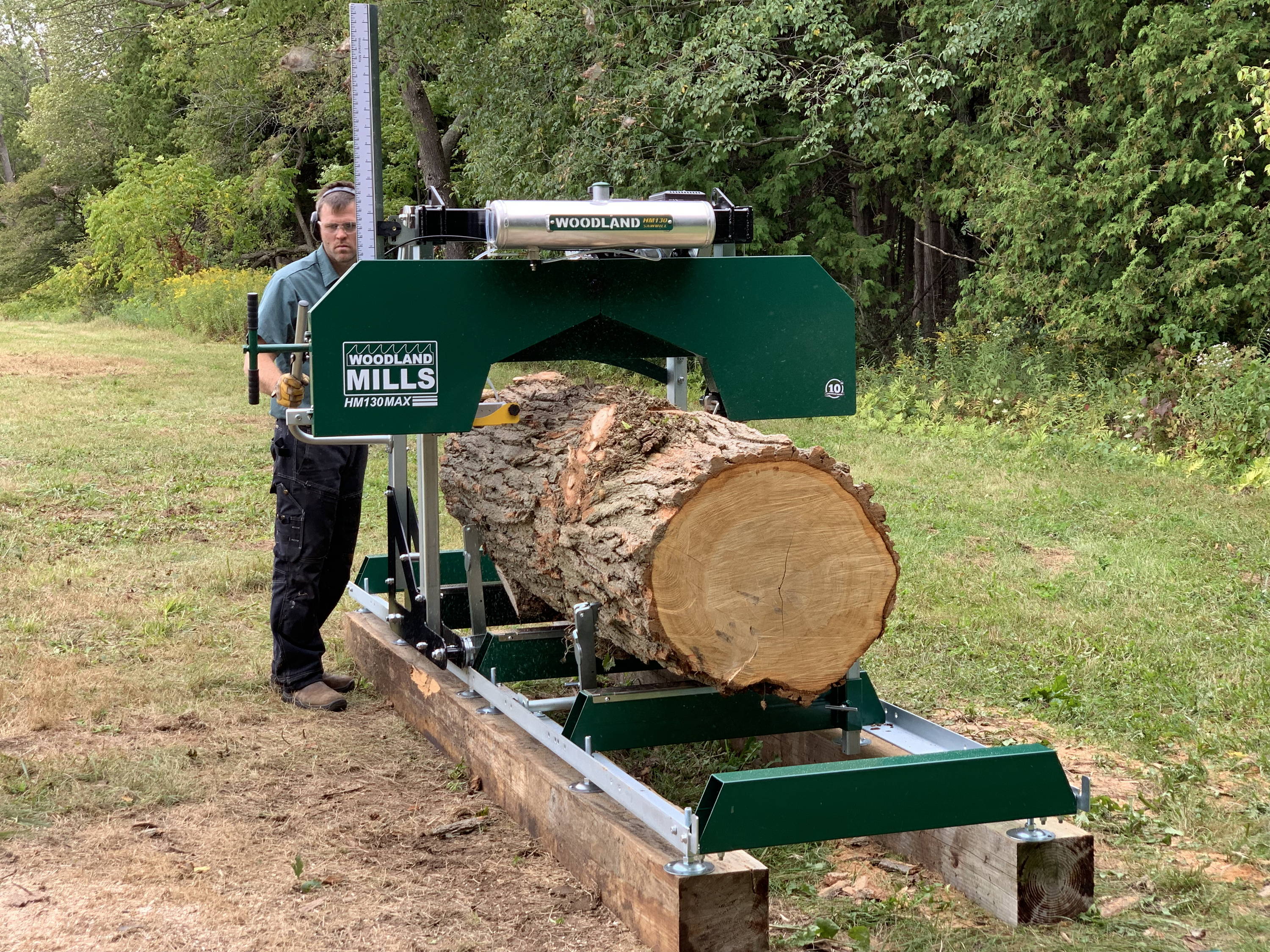 HM130MAX sawmill cutting through a large tree trunk