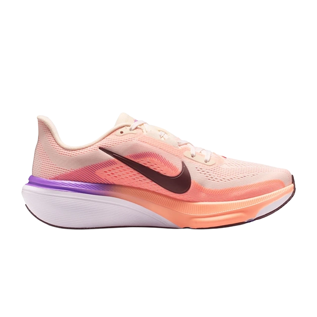 Nike running shoe in peach and purple colors.