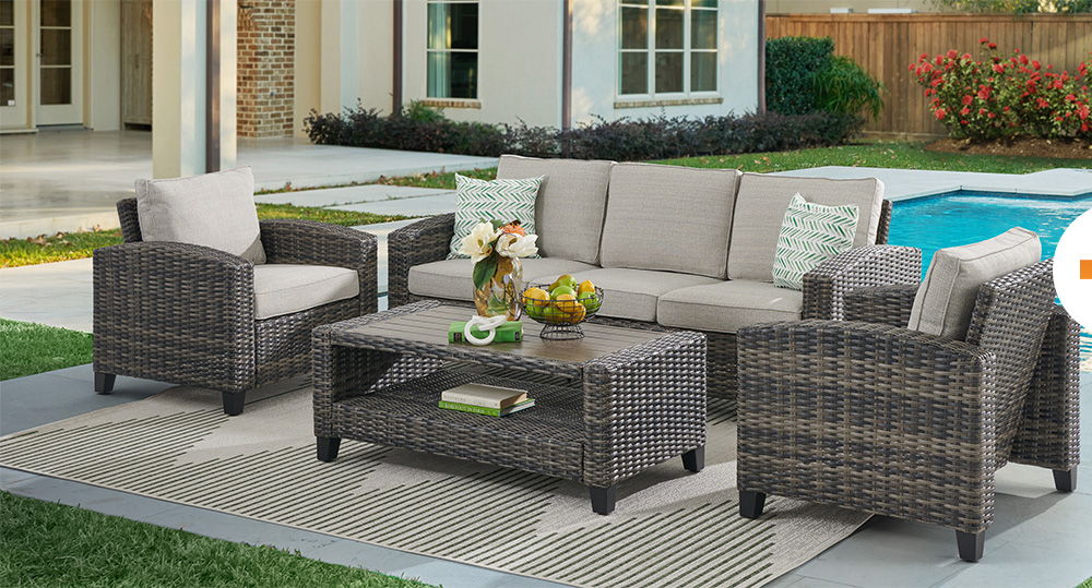 Outdoor seating area with a sofa, chairs, and coffee table.