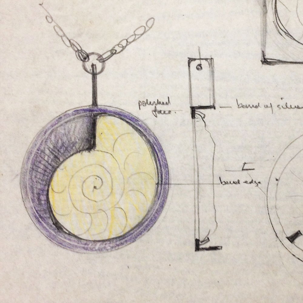 Illustration of a pendant design featuring a spiral shell motif.