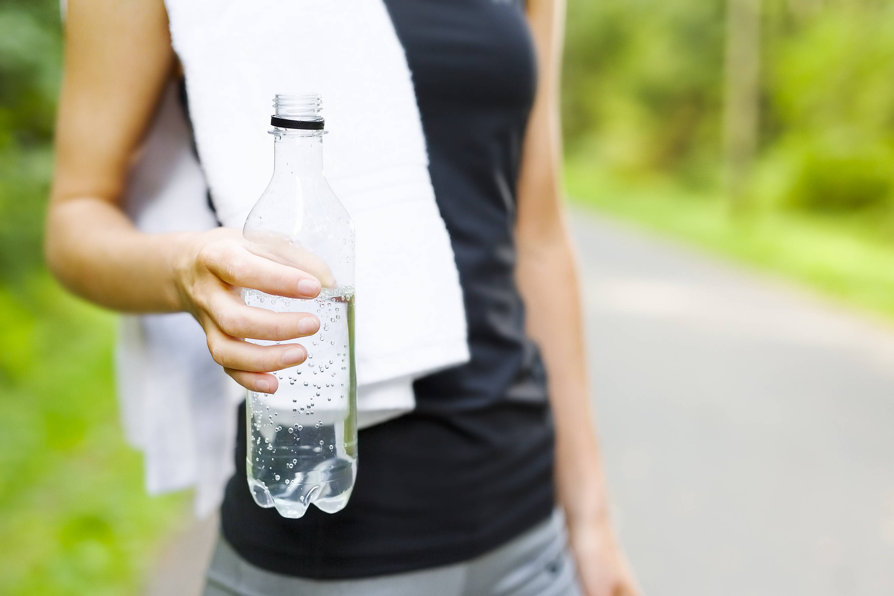 Lady after exercise drinking water. 