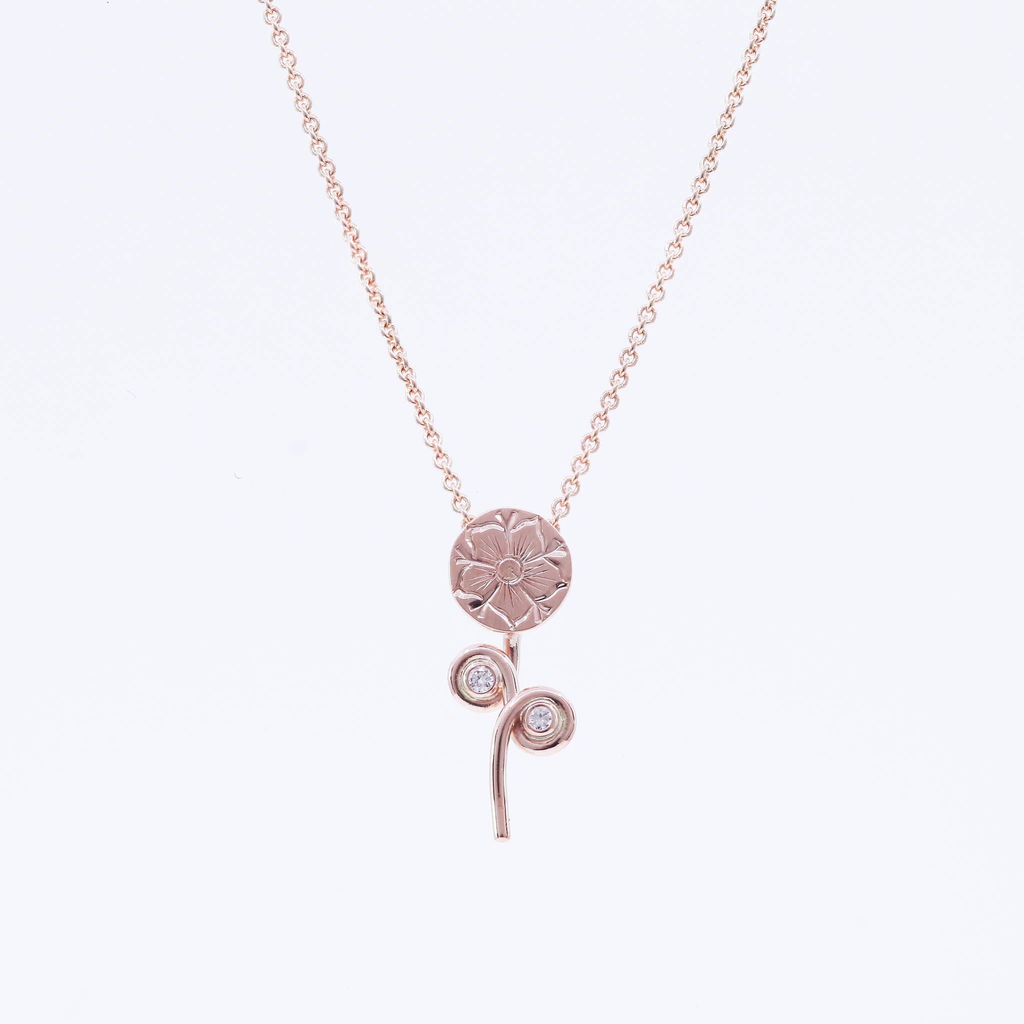hand carved flower with diamond accents in rose gold