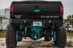 Rear view of black lifted Silverado 2500 with teal suspension thumbnail