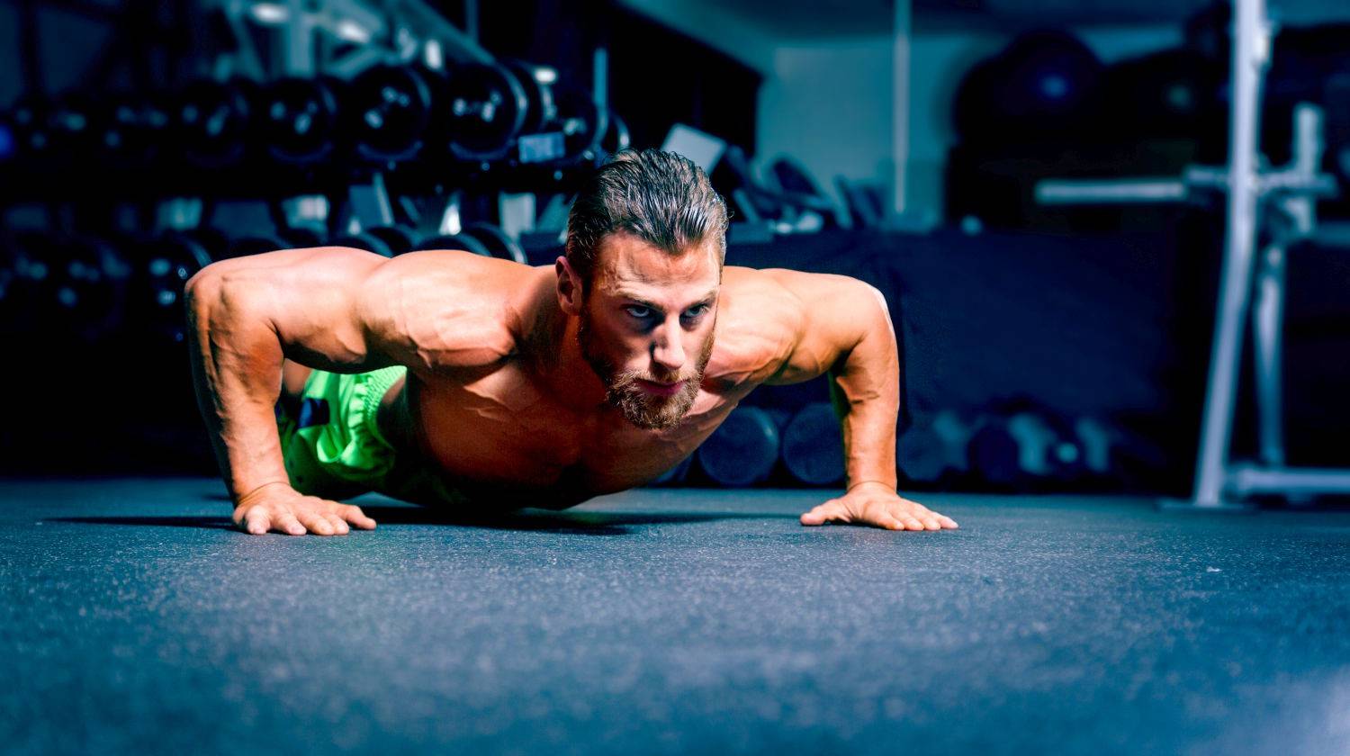 Ambassador Tim McComsey doing wide angled pushup | The Best Super High-Rep Training With HIIT 100s Workout | Featured | hiit workouts with weights