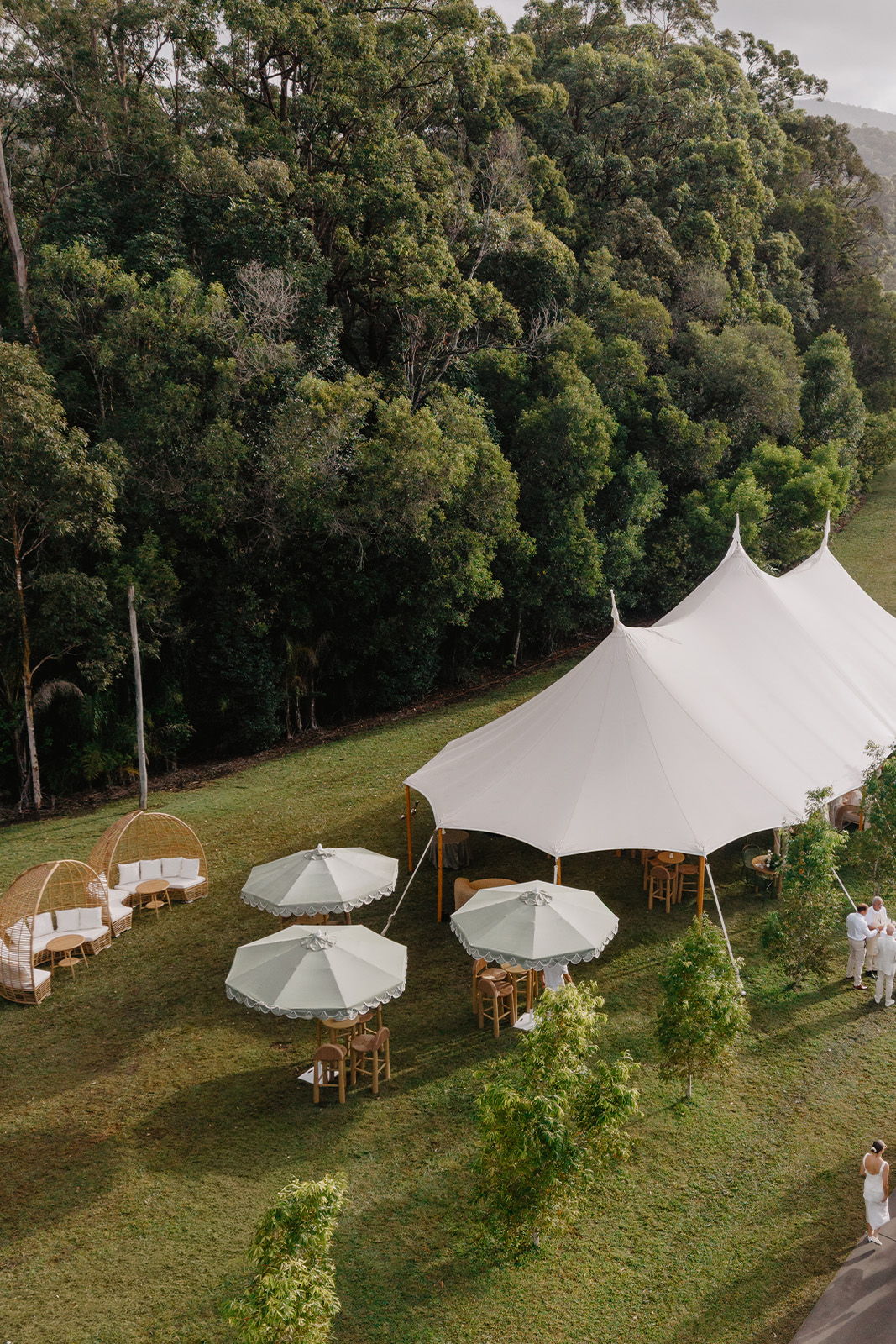 Outdoor event setup with a large tent and seating arrangements.