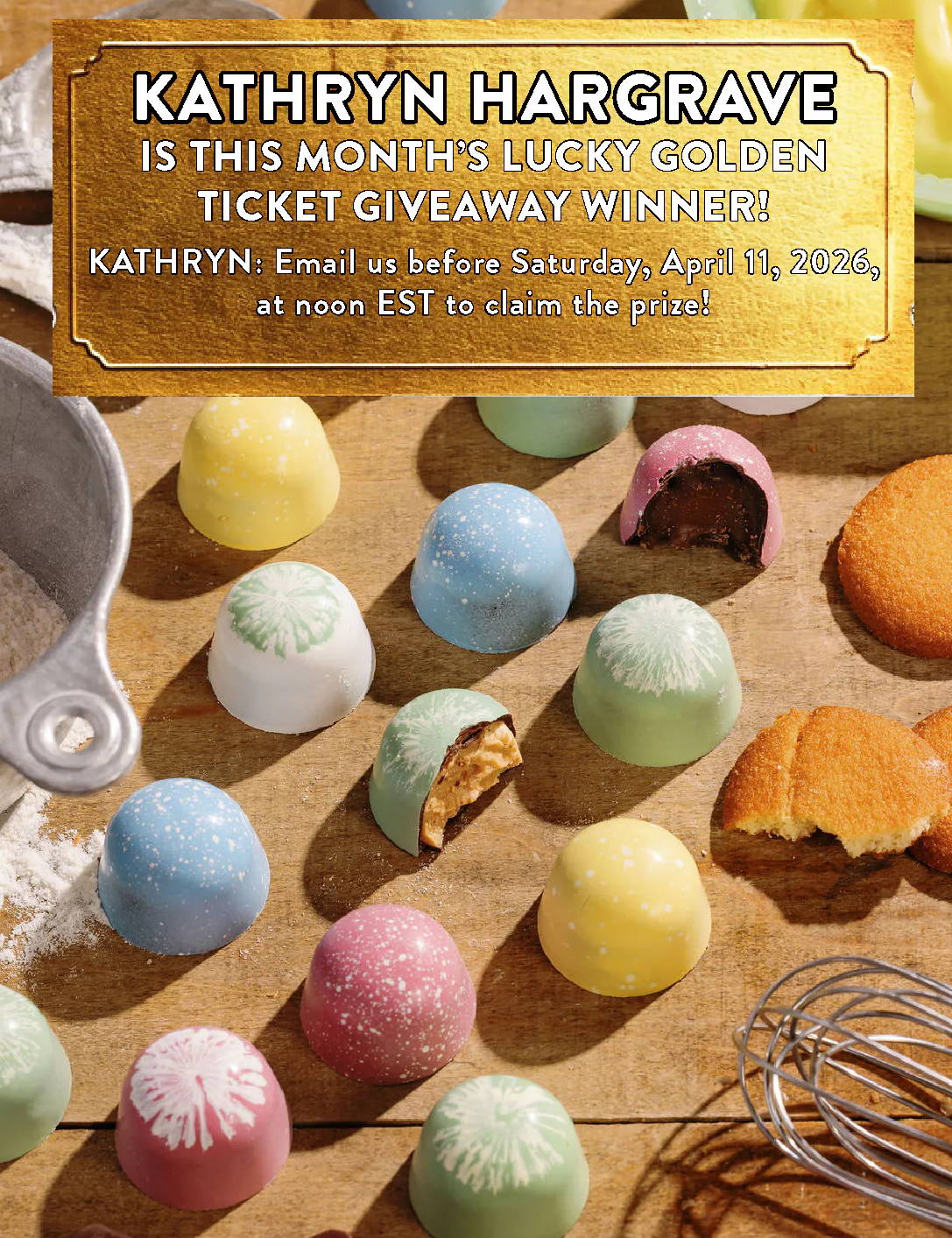 Colorful macarons on a wooden surface with baking tools.
