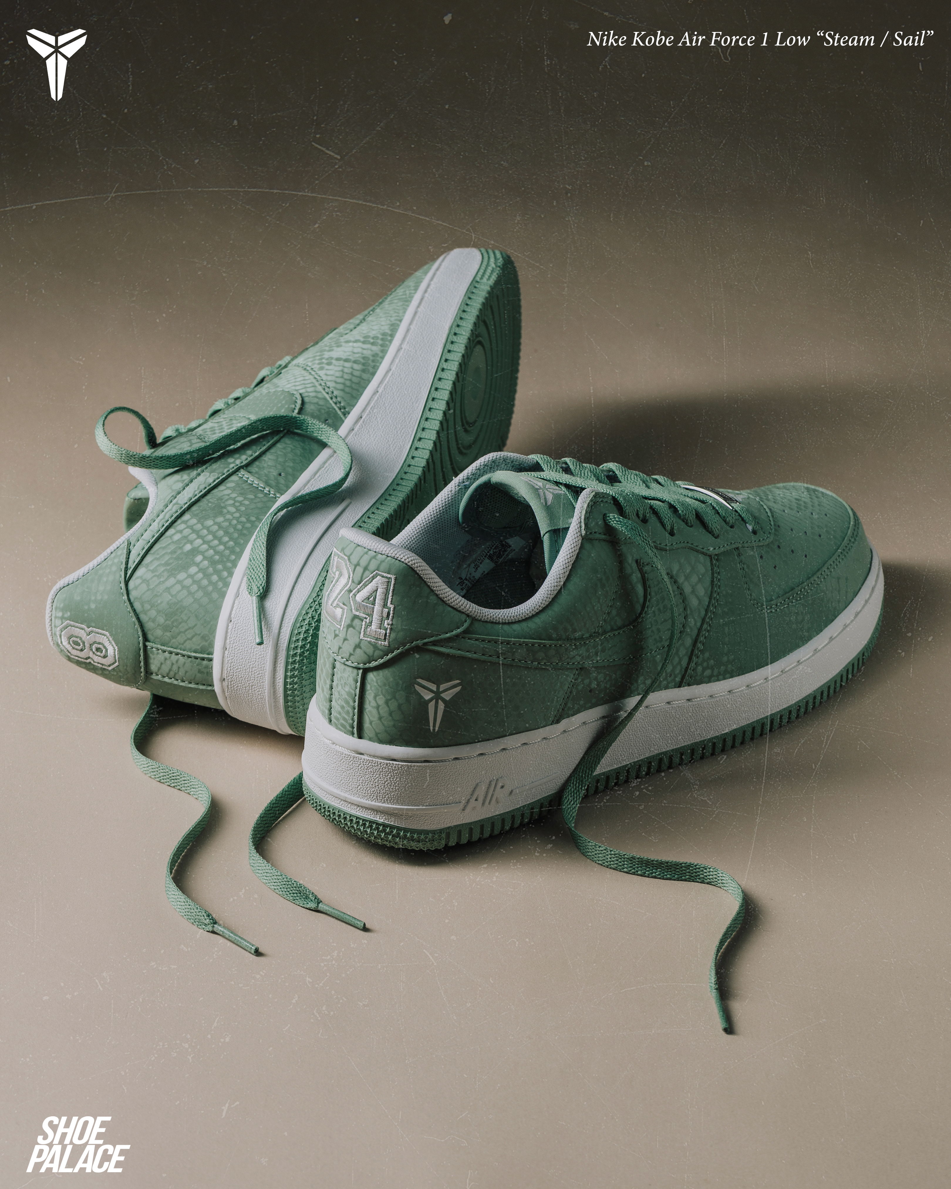 Green sneakers with laces, featuring a logo on the side.