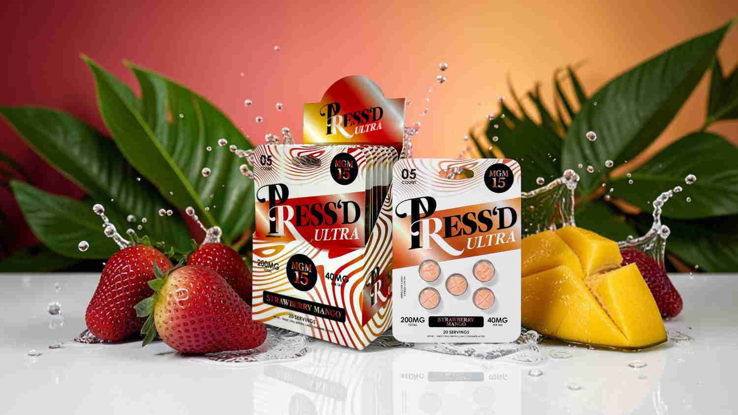 Bottles of juice surrounded by strawberries and mangoes with splashes of water.