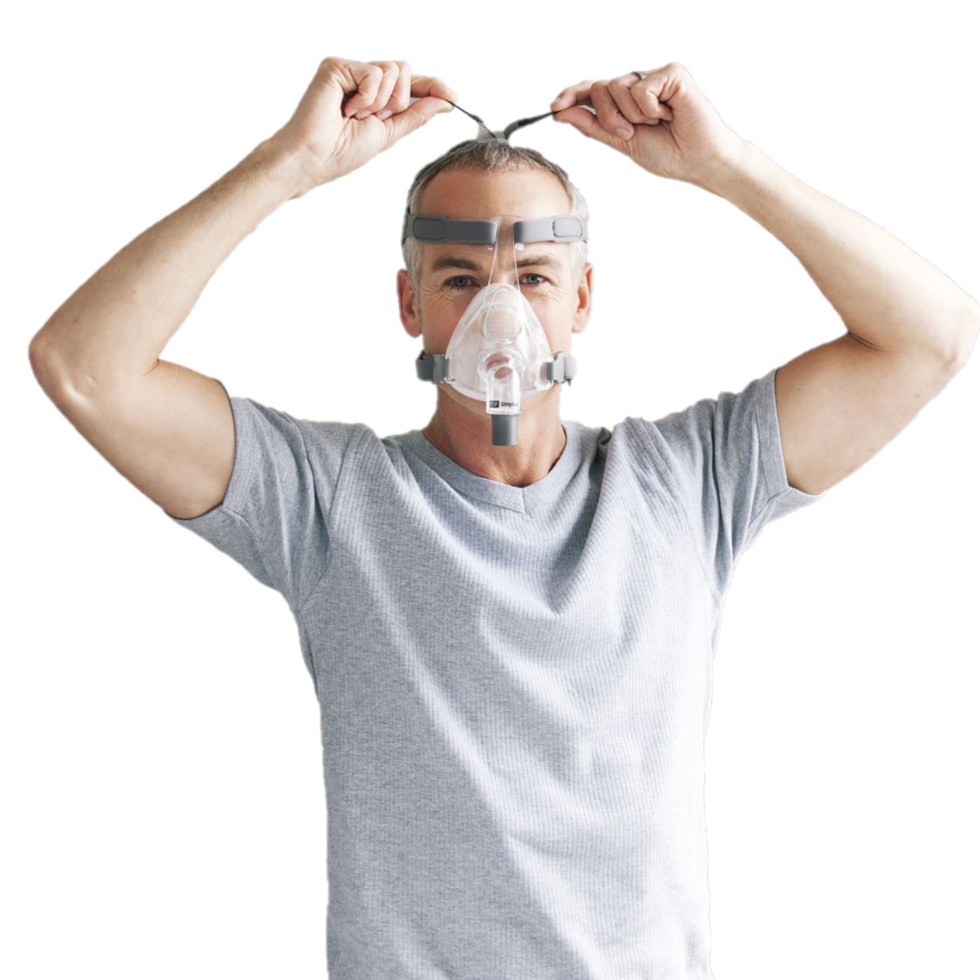 Stock photo of man wearing Fisher & Paykel Simplus full face CPAP mask with headgear