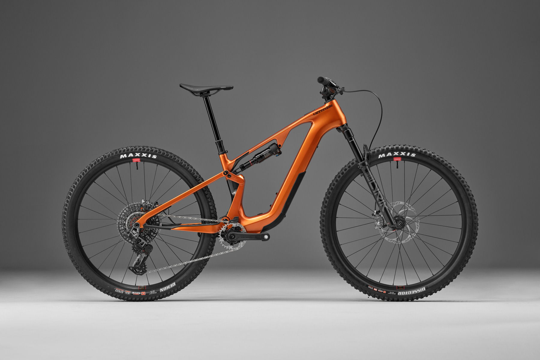 Orange mountain bike on a gray background.