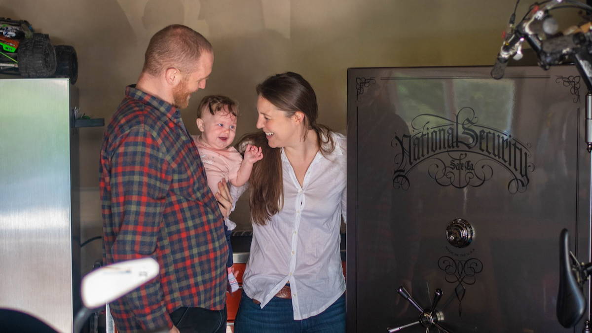 mom and dad opening a gun safe with their baby girl