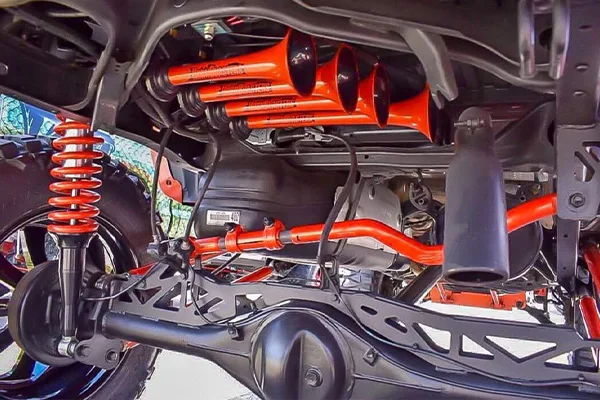 Underside four orange red train horns rear axle red sway bar lattice control arms black tank Billy's Tacoma 244K gallery photo 4